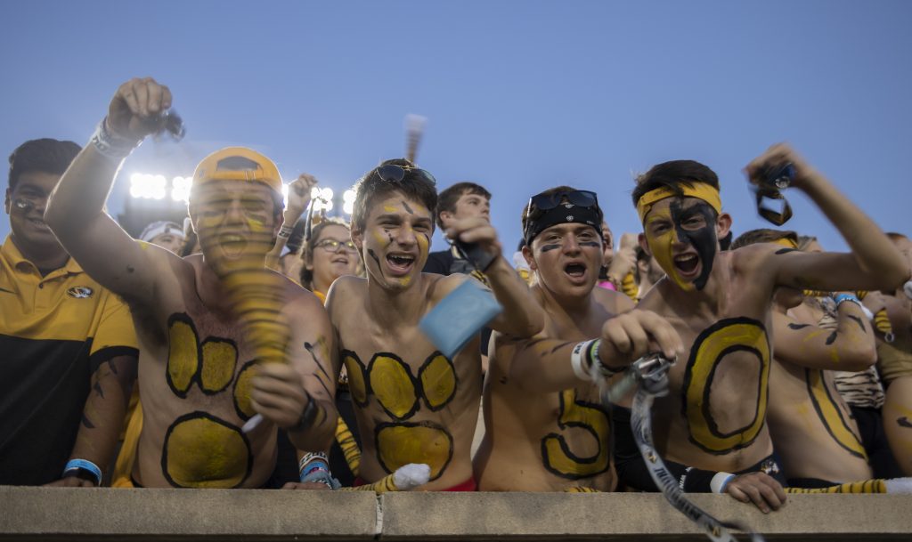 Students celebrate their tiger spirit at a football game.